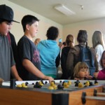 Teens playing foosball