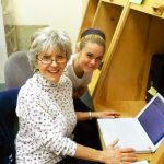 Teen helping Senior with computer questions