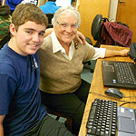 Teens helping Senior with computers on Senior Tech Day